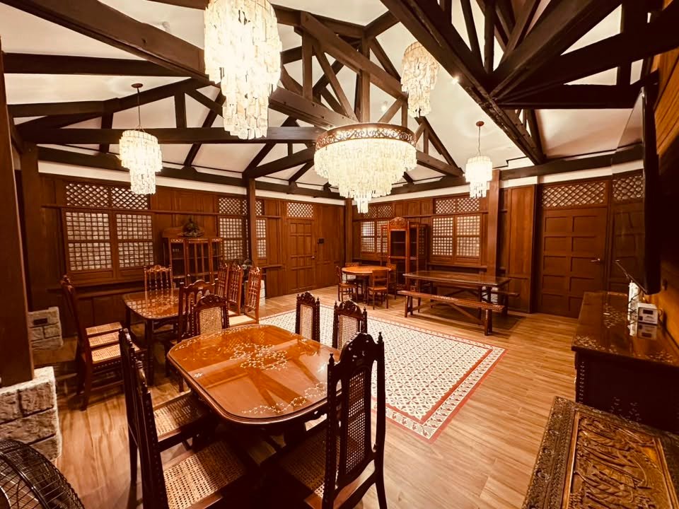 The Komedor dining hall — carved hardwood tables and chairs under capiz shell chandeliers